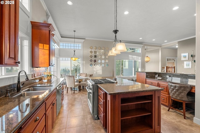 kitchen featuring sink, a center island, pendant lighting, appliances with stainless steel finishes, and ornamental molding