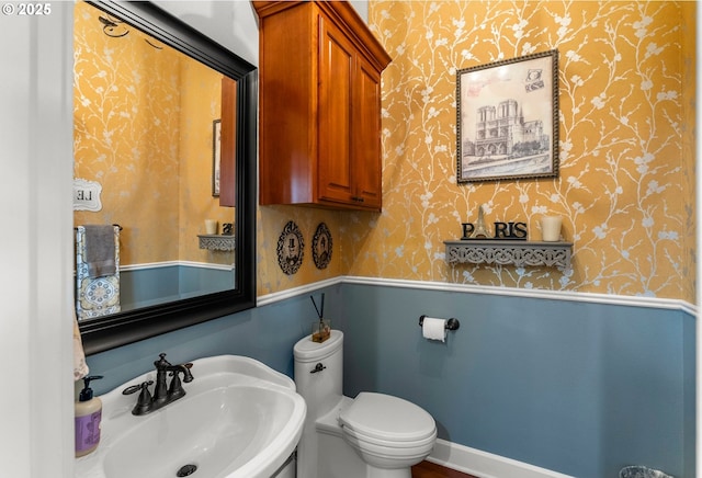 bathroom featuring toilet and sink