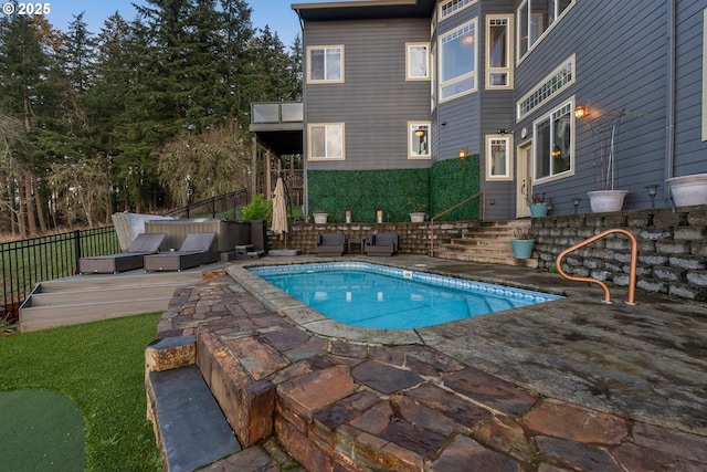 view of swimming pool with a patio and a hot tub