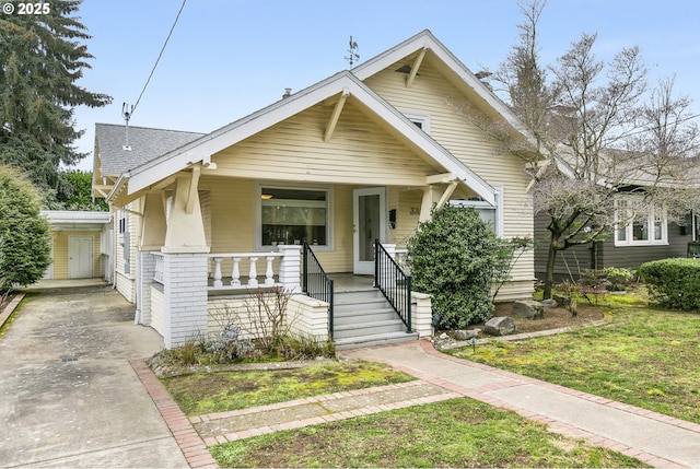 bungalow-style house with a porch and roof with shingles