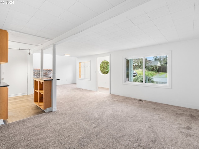 unfurnished living room with light carpet