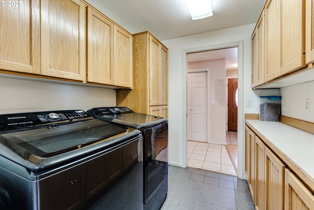 1278 Winery Ln, Eugene, OR 97404 - laundry area with washer and clothes dryer, cabinet space, and light tile patterned floors