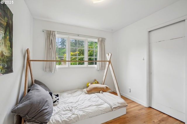 4242 SW Admiral St, Portland, OR 97221 - bedroom with light wood-style floors and baseboards