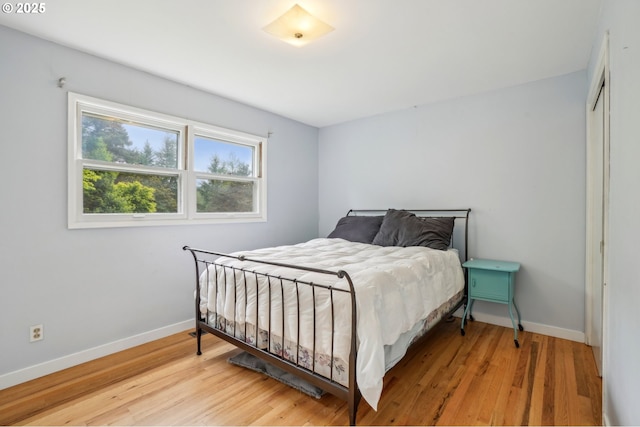 4242 SW Admiral St, Portland, OR 97221 - bedroom with baseboards, light wood-type flooring, and a closet
