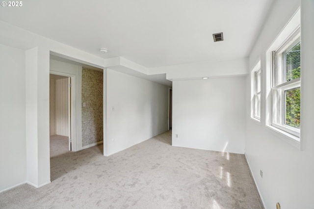 4242 SW Admiral St, Portland, OR 97221 - carpeted empty room featuring plenty of natural light, a smoke detector, and baseboards
