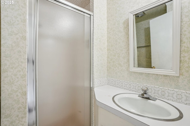 4242 SW Admiral St, Portland, OR 97221 - full bath featuring wallpapered walls, vanity, and a shower with door