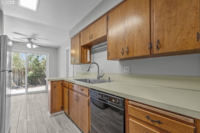 4004 Ginkgo Ave, Tillamook, OR 97141 - kitchen featuring dishwasher, a sink, freestanding refrigerator, and brown cabinetry
