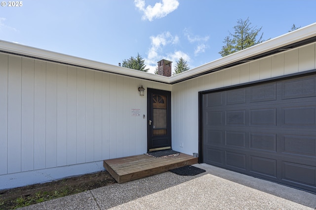 4004 Ginkgo Ave, Tillamook, OR 97141 - doorway to property featuring a chimney, driveway, and an attached garage