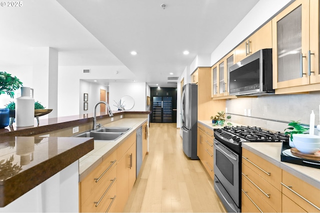 700 Washington St Unit 925, Vancouver, WA 98660 - kitchen with appliances with stainless steel finishes, a sink, light brown cabinets, light wood-style flooring, and recessed lighting