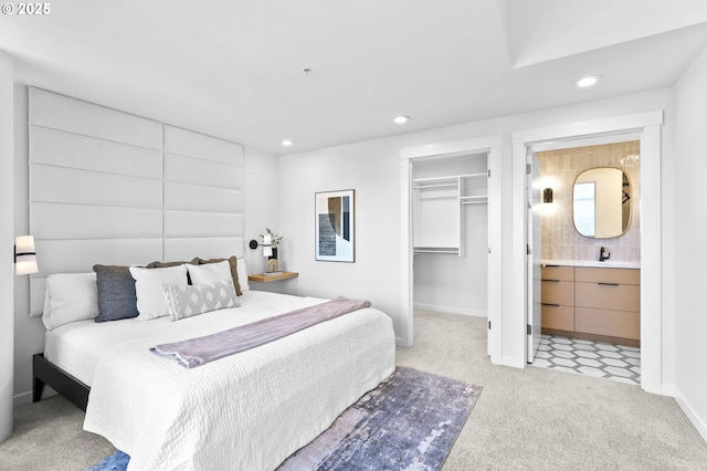 700 Washington St Unit 925, Vancouver, WA 98660 - bedroom featuring carpet, recessed lighting, a walk in closet, ensuite bath, and a sink