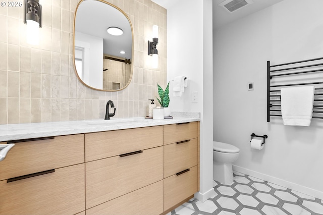 700 Washington St Unit 925, Vancouver, WA 98660 - full bathroom featuring vanity, toilet, baseboards, a towel warmer, and tiled shower