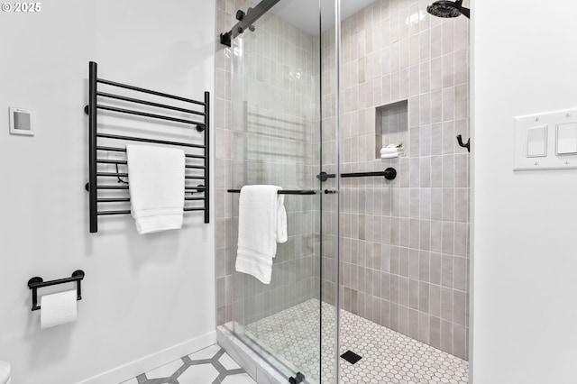 700 Washington St Unit 925, Vancouver, WA 98660 - bathroom featuring radiator, a stall shower, a towel warmer, and baseboards