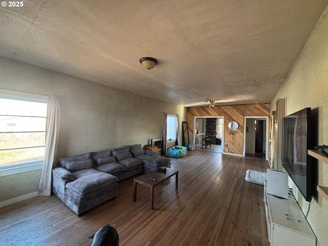 living room with hardwood / wood-style floors and wooden walls