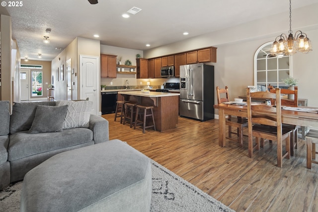 living room with sink, hardwood / wood-style floors, and a textured ceiling