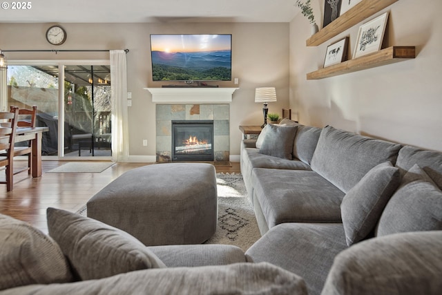 living room featuring light hardwood / wood-style floors and a tile fireplace