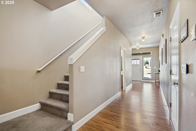 entrance foyer featuring hardwood / wood-style flooring and a textured ceiling