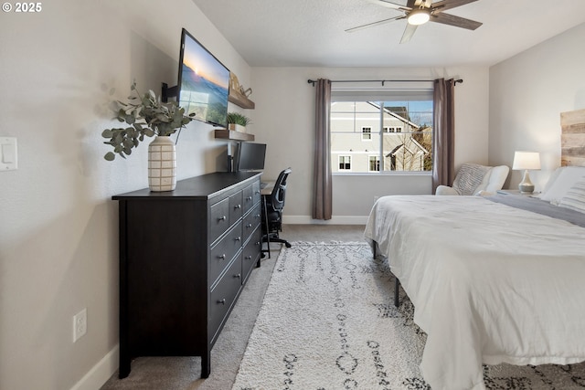 bedroom featuring light carpet and ceiling fan