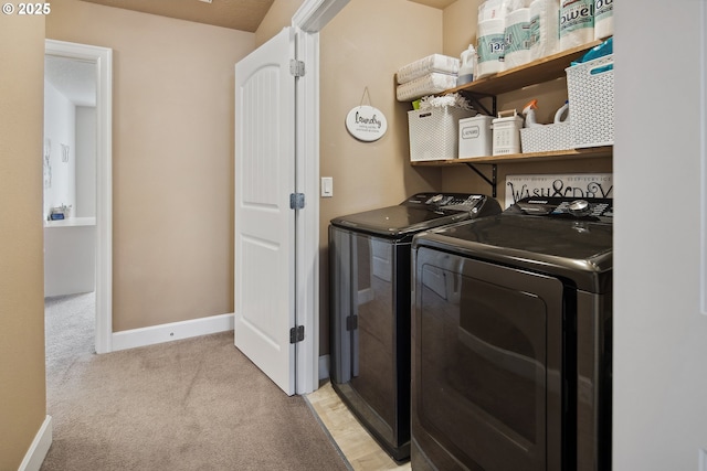 clothes washing area with independent washer and dryer and light colored carpet