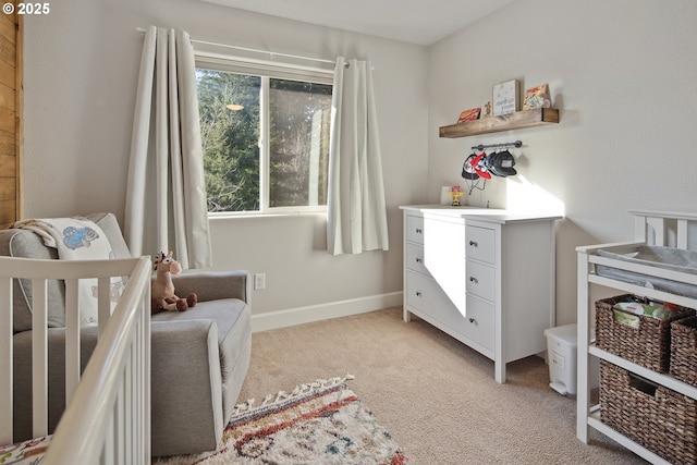 bedroom featuring a nursery area and light colored carpet