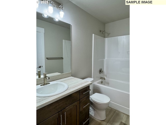 full bathroom with  shower combination, vanity, toilet, and wood finished floors