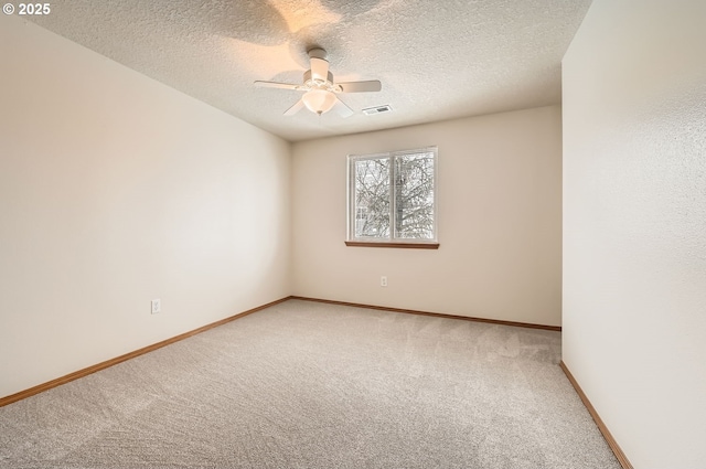 carpeted empty room with a textured ceiling and ceiling fan