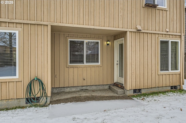 view of snow covered property entrance