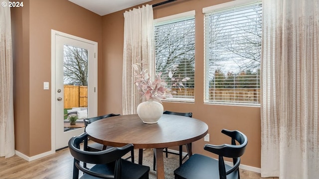 dining area featuring light hardwood / wood-style floors and a healthy amount of sunlight