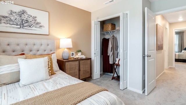 bedroom featuring light colored carpet and a closet