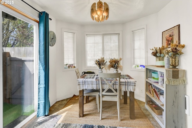 dining area with baseboards and a notable chandelier