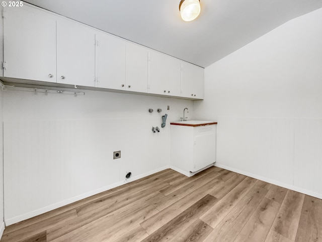 laundry room featuring light wood-type flooring, washer hookup, a sink, cabinet space, and hookup for an electric dryer