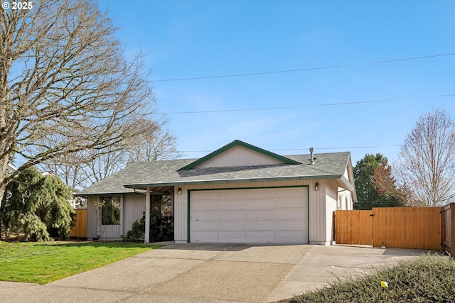 ranch-style house featuring an attached garage, a front yard, a gate, fence, and driveway