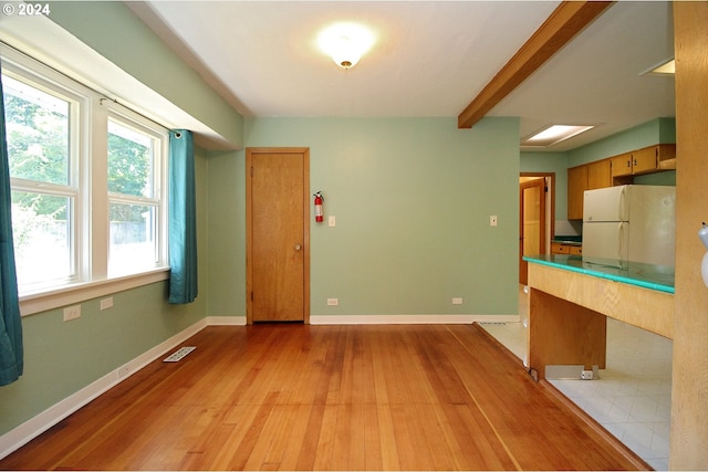 2309 SE 90th Ave, Portland, OR 97216 - kitchen featuring freestanding refrigerator, light wood finished floors, baseboards, and beam ceiling