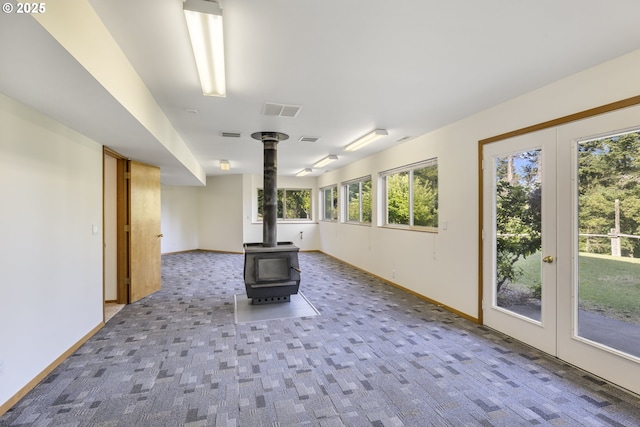 4719 Westwood Dr, Hood River, OR 97031 - spare room featuring carpet, a wood stove, and baseboards