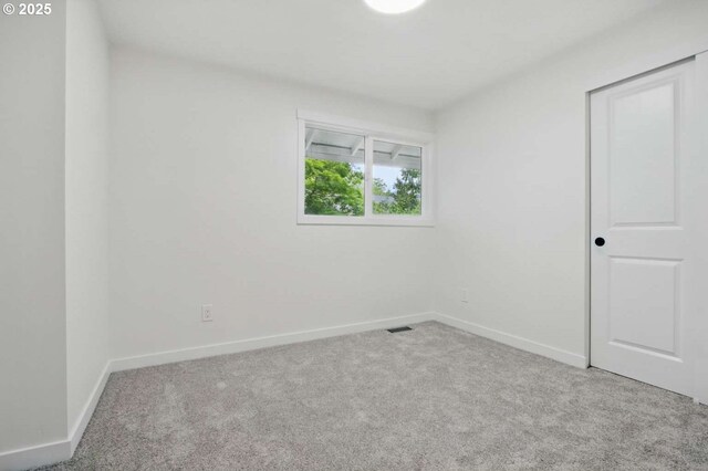 carpeted empty room with baseboards