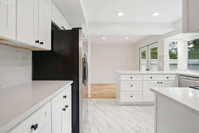 kitchen with stainless steel appliances, white cabinets, light marble finish flooring, backsplash, and recessed lighting