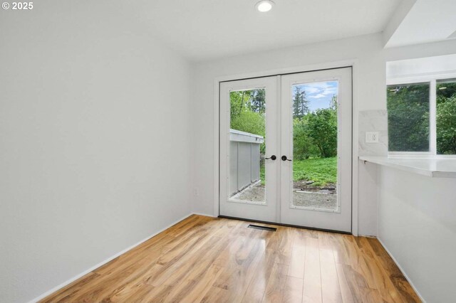 entryway featuring french doors, wood finished floors, recessed lighting, and baseboards
