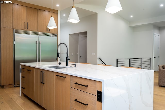 480 W U St, Washougal, WA 98671 - kitchen with a sink, light wood finished floors, modern cabinets, light stone counters, and stainless steel built in fridge