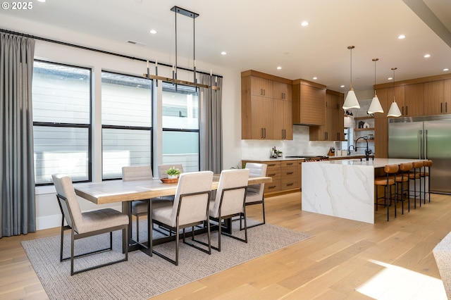 480 W U St, Washougal, WA 98671 - kitchen featuring appliances with stainless steel finishes, modern cabinets, decorative backsplash, light wood-type flooring, and recessed lighting