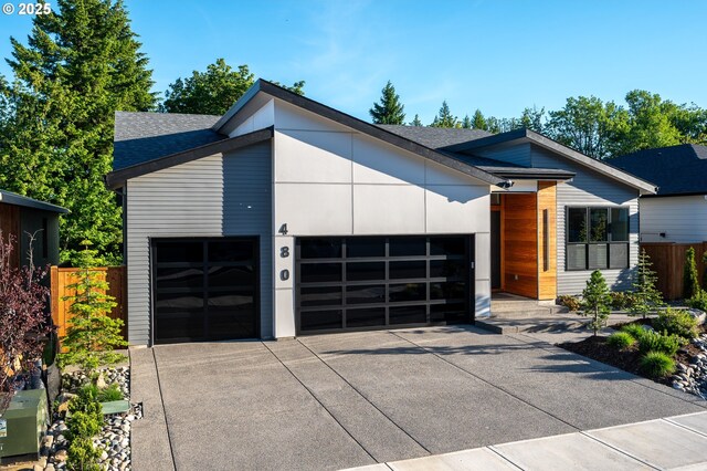 480 W U St, Washougal, WA 98671 - contemporary house featuring a garage, concrete driveway, and a shingled roof