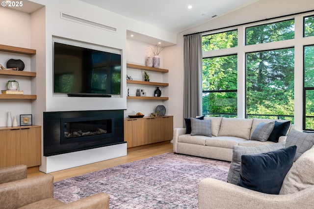 480 W U St, Washougal, WA 98671 - living area featuring a glass covered fireplace, light wood-style floors, vaulted ceiling, recessed lighting, and built in shelves