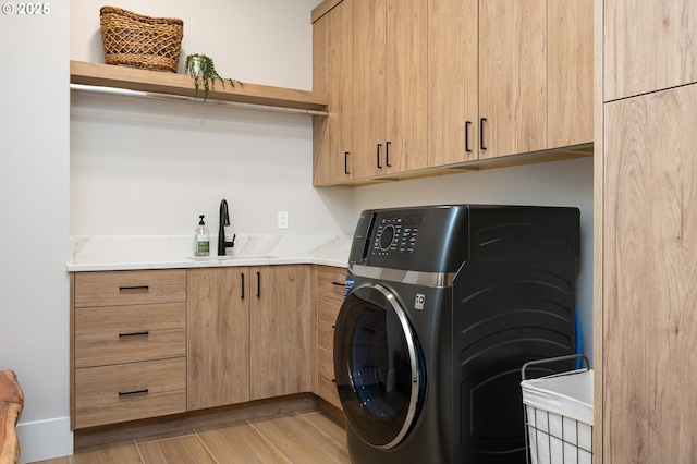 480 W U St, Washougal, WA 98671 - washroom with cabinet space, washer / clothes dryer, and light wood-type flooring