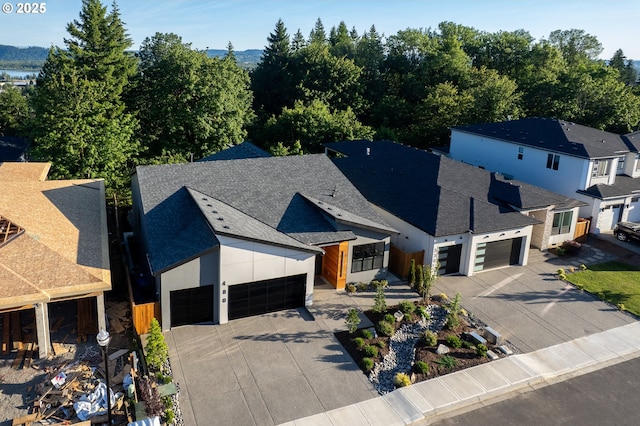 480 W U St, Washougal, WA 98671 - view of front of home with driveway, an attached garage, roof with shingles, and a residential view