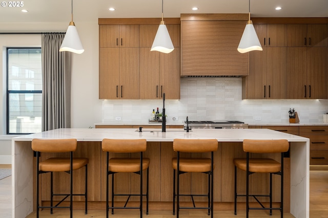 480 W U St, Washougal, WA 98671 - kitchen with backsplash, a kitchen island with sink, a sink, hanging light fixtures, and recessed lighting