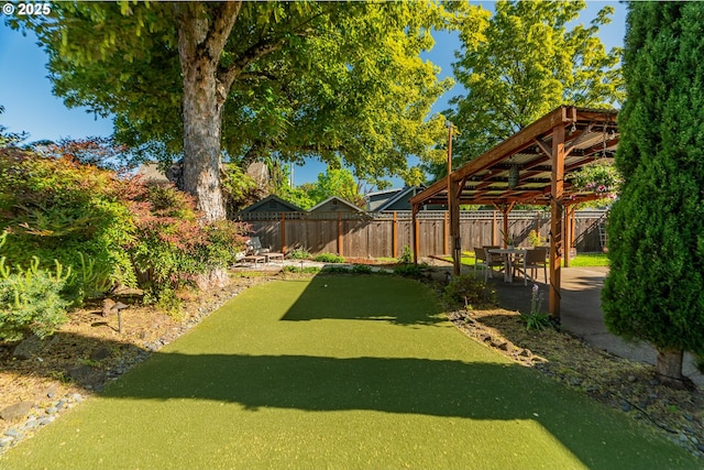 fenced backyard with a gazebo and a putting green