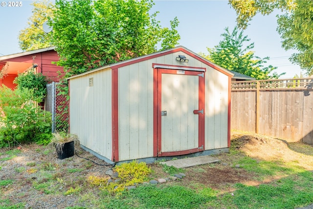 view of shed featuring fence