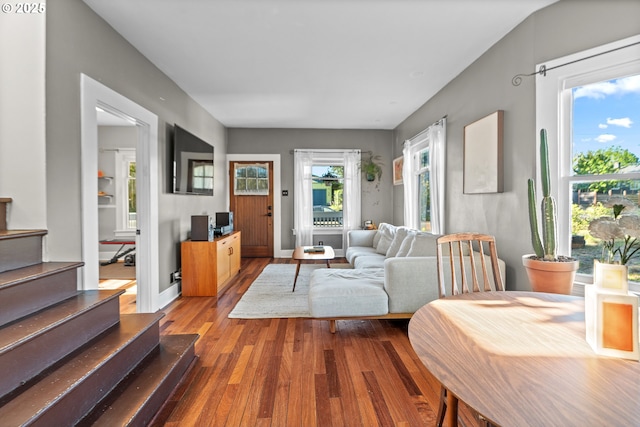 living room with wood finished floors and stairs