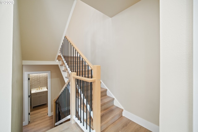 stairs featuring hardwood / wood-style flooring