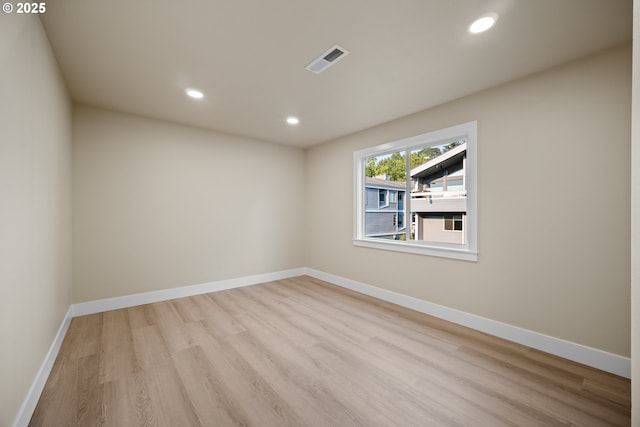 unfurnished room with light hardwood / wood-style flooring