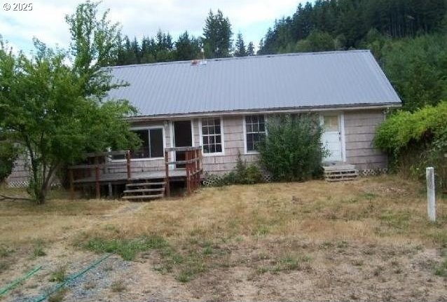 back of house featuring a deck