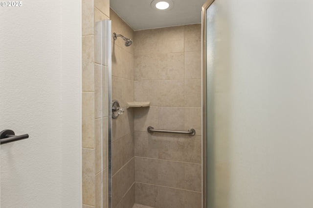 bathroom with a tile shower